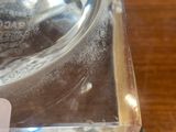 a glass bowl with a label on it sitting on a table