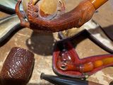 a lot of different types of smoking pipes on the table