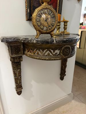 a clock sitting on top of a table in a room
