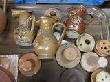 many different types of pottery sitting on a table