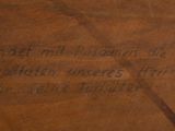a close up of a piece of wood with writing on it