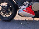 a red and black motorcycle parked in a parking lot
