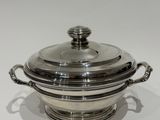 a silver plated casserole with a lid and handles