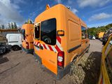an orange van that is parked in a parking lot