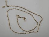 a close up of a gold chain with a cross on it