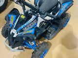 an image of a blue and black atv in a showroom
