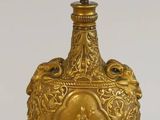 une image représentant une lampe dorée surmontée d'une lumière blanche