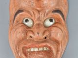 an image of a clay mask on a wall