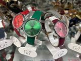 many different colored watches on display in a glass case
