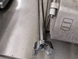 stainless steel counter top with tools on it in a commercial kitchen