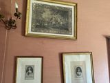 pictures hanging on the wall of a room with pink walls