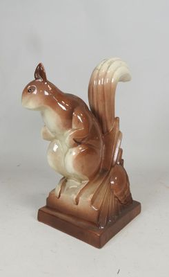 a figurine of a squirrel that is sitting on a table