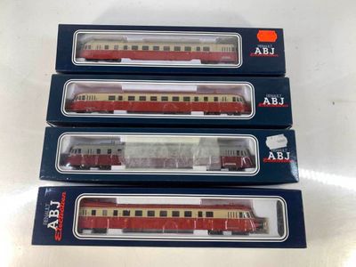 three red and beige train cars sitting on top of each other