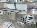 stainless steel counter top with a glass display case and menus