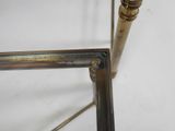 a close up of a metal table with a glass top
