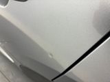 someone is peeling the paint off of a car ' s door handle