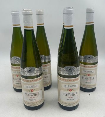 six bottles of wine are lined up on a white surface