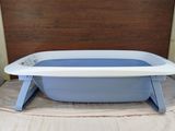 a blue and white bath tub sitting on a wooden table