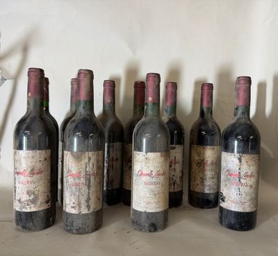 several bottles of wine are lined up on a table