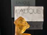 yellow glass figurine of a dog on a black table