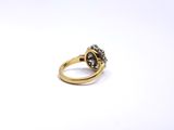 an image of a gold and diamond ring on a white surface