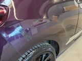 a purple car that has a sticker on the side of it