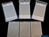 four clear plastic cards in a row on a black background
