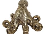 an image of a gold octopus figurine on a white background