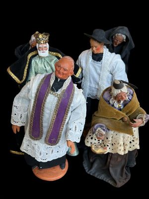 three figurines of men dressed in medieval clothing