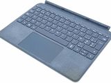 an open laptop computer sitting on top of a white surface