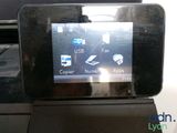a cell phone that is sitting on top of a printer