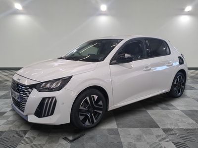 a white car is parked on a checkered floor in a garage