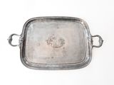 a silver tray with handles on a white surface