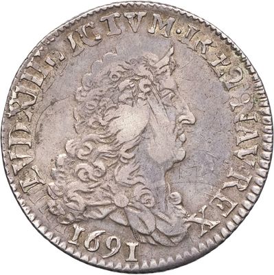 gros plan d'une pièce de monnaie sur laquelle figure une tête de femme