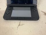 a black nintendo wii game system sitting on a table
