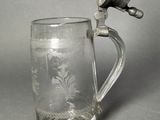 a glass mug that has a handle on it
