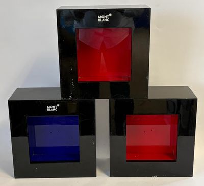 three black boxes with red, blue, and red glass in them