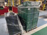 a large stack of green boxes sitting on a pallet in a warehouse