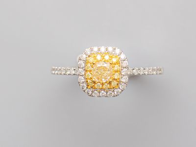 a yellow diamond and diamond ring