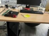 a desk with a computer monitor and keyboard on it