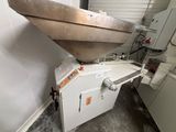 a boat sitting on top of a machine in a room