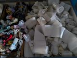 many rolls of fabric in a box with scissors