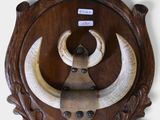 a wooden wall mounted with a bull ' s head on it