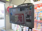 a television that is on in the corner of a store