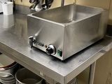 a stainless steel counter with a microwave on top of it