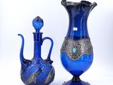 two blue vases sitting next to each other on a white surface