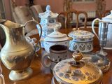 a table with a lot of tea and coffee pots on it