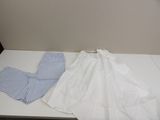 two pairs of pants sitting on a table next to each other