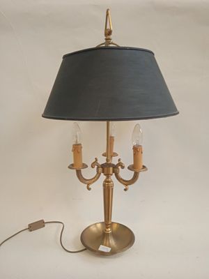 a lamp that is on a table with a black shade