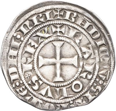 une pièce d'argent sur laquelle figure une croix au recto